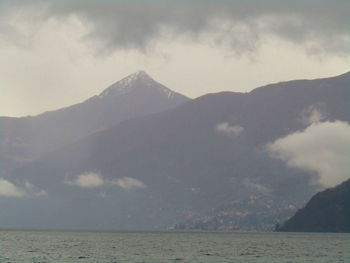 Scenic view of sea and mountains against sky