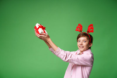 Portrait of a smiling young woman against gray background