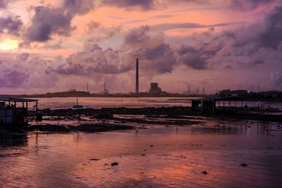 Smoke emitting from chimney against sky at sunset