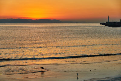 Scenic view of sea against orange sky