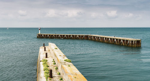 Pier over sea against sky