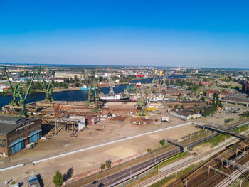 High angle view of cityscape against blue sky