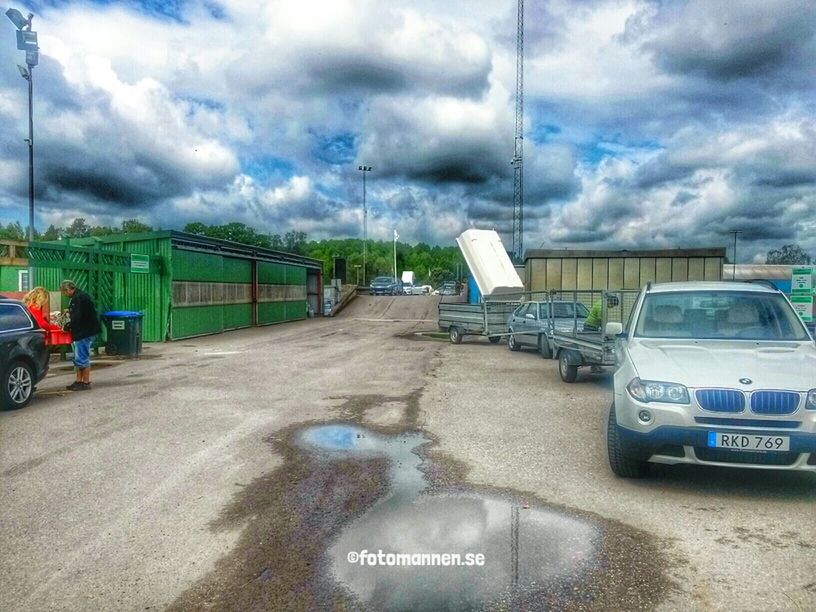 transportation, sky, cloud - sky, land vehicle, cloudy, mode of transport, road, car, cloud, street, road marking, the way forward, weather, day, text, overcast, outdoors, western script, travel, road sign