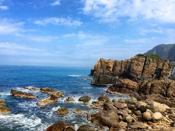 Scenic view of sea against cloudy sky