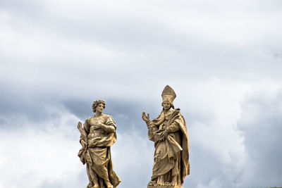 Low angle view of angel statue against sky