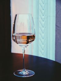 Close-up of white wine in glass on table