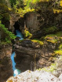 High angle view of stream amidst rocks