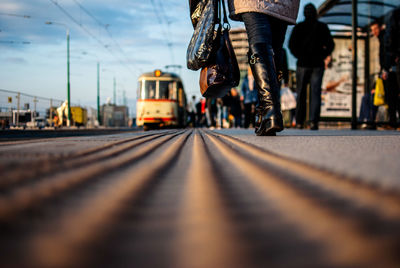 Surface level of woman walking by tramway