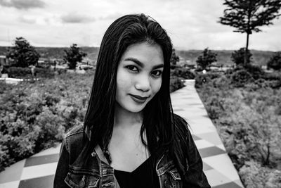 Portrait of smiling young woman standing outdoors