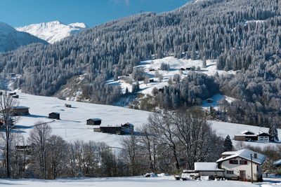 Snow covered landscape against mountains