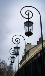 Low angle view of street lights against sky