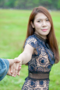 Portrait of a smiling young woman lying on field