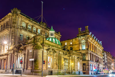 Low angle view of illuminated building at night