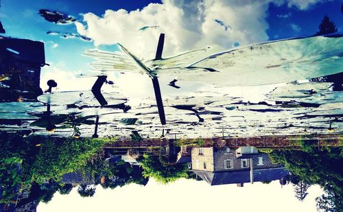 Reflection of buildings on water against sky