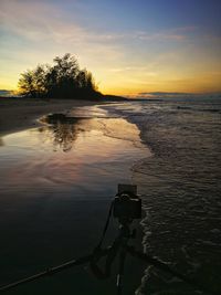 Scenic view of lake against orange sky