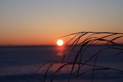 Scenic view of sea against romantic sky at sunset