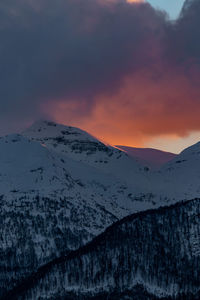 Scenic view of snowcapped mountains against sky during sunset