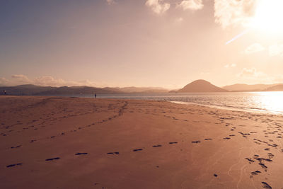 Scenic view of beach against sky during sunset