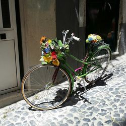 Bicycle parked on footpath by building