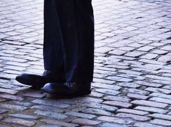 Low section of woman standing on tiled floor