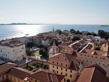 High angle view of townscape by sea
