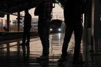 Low section of silhouette people standing on floor