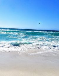 Scenic view of sea against clear blue sky