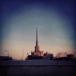 Built structures against sky at sunset