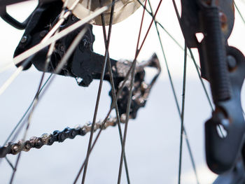 Low angle view of bicycle hanging on rope