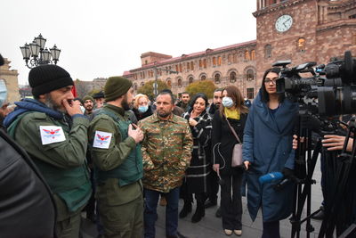 Group of people standing against built structures