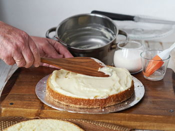 Close-up of hand holding food on table