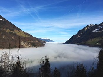 Scenic view of lake and mountains against sky