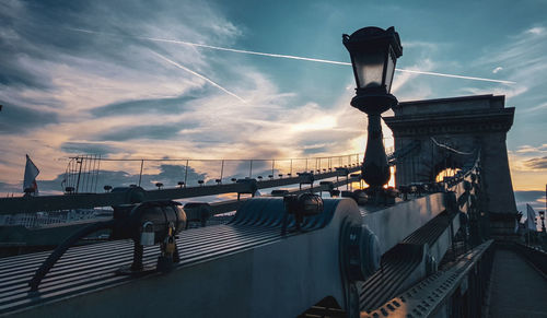 View of bridge against cloudy sky during sunset