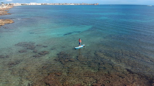 High angle view of man swimming in sea