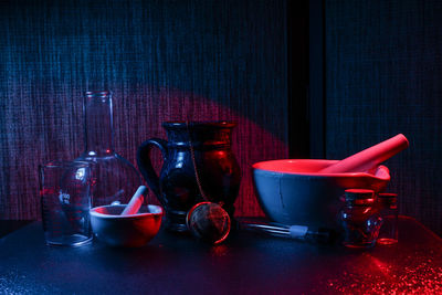 Mortar and pestle in containers on table