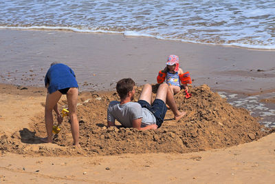 Rear view of people on beach