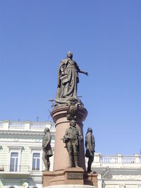 Low angle view of statue against blue sky