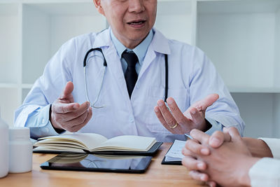 Low angle view of man using smart phone on table