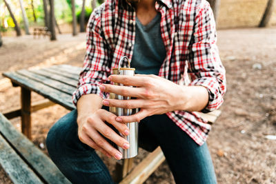 Midsection of man sitting on bench