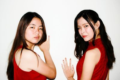 Portrait of beautiful young woman over white background