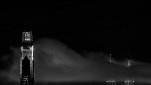 Illuminated buildings against sky at night