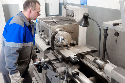 Side view of man working in factory