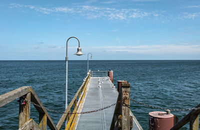 Pier over sea against sky