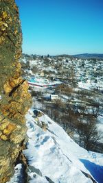 Scenic view of snowy landscape against clear blue sky