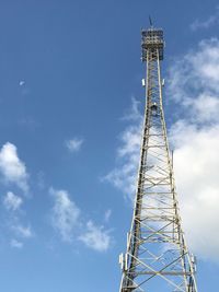 Low angle view of communications tower against sky