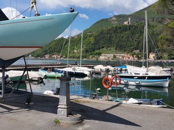 Boats moored in sea against mountains