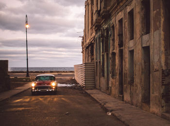 Cars on street amidst buildings in city