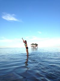 Full length of man in sea against sky