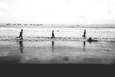 Men running on beach