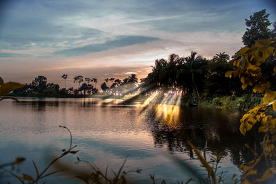 Scenic view of lake against sky at sunset